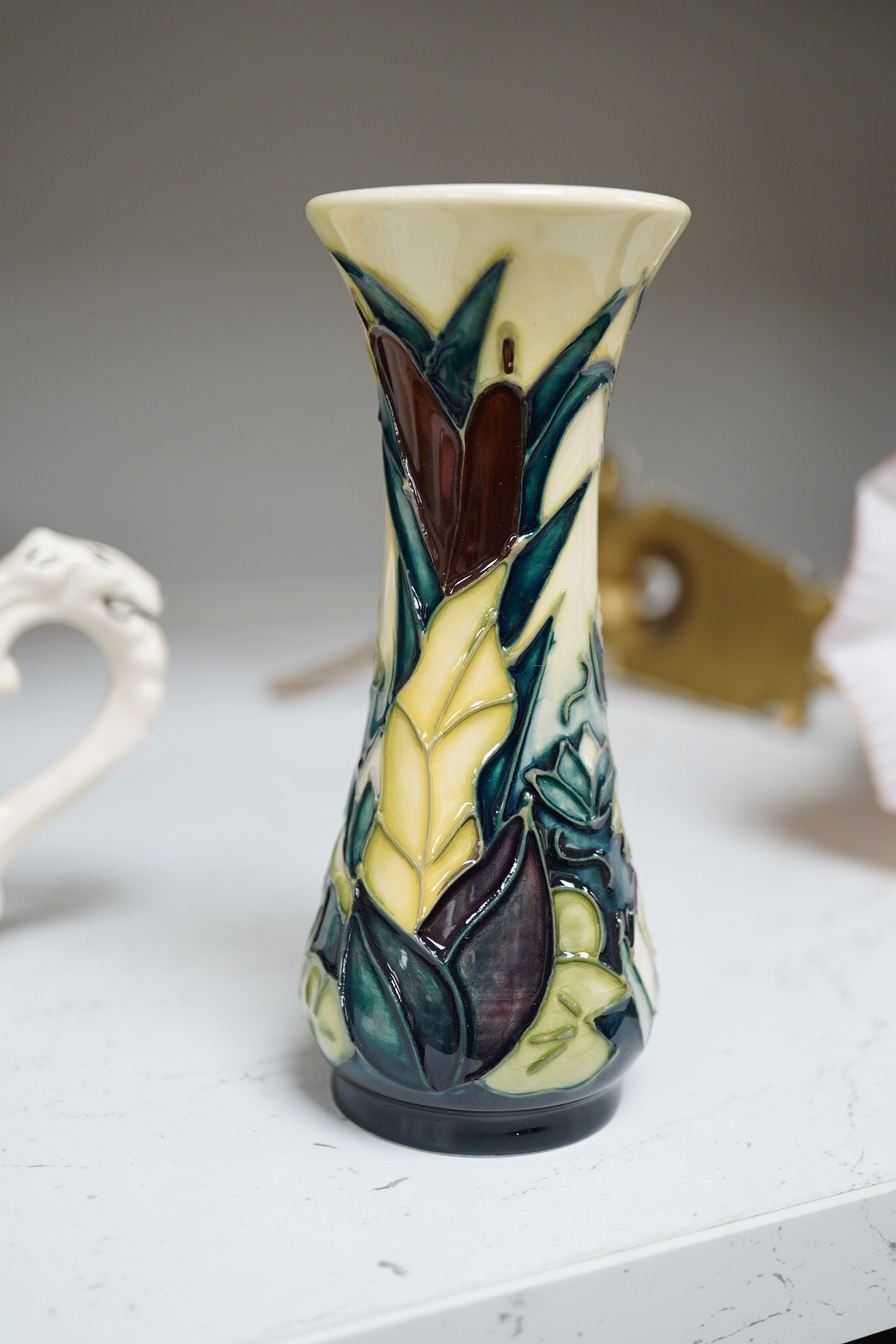 Ceramics comprising a Moorcroft mug (restored), a Dame Laura Knight mug, both Royal commemorative, Moorcroft vase and Clarice Cliff dish, largest 26cm in diameter. Condition - varies